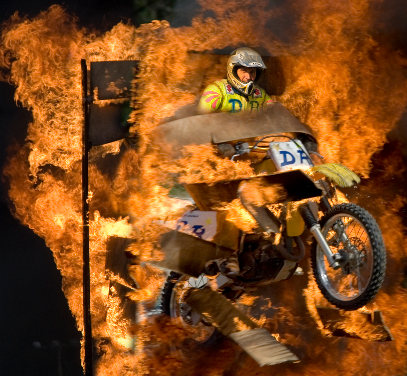 David Russell jumping through a wood wall on fire!